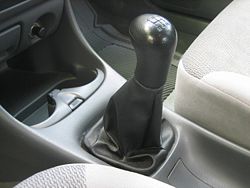 5 speed shift stick of a 1999 Mazda Protege.
