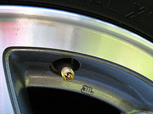 https://upload.wikimedia.org/wikipedia/commons/thumb/0/02/Tire_valve_stem-cap_off.jpg/220px-Tire_valve_stem-cap_off.jpg